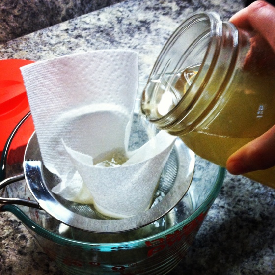 I strain the kefir through a paper towel lined sieve since metal can kill the grains